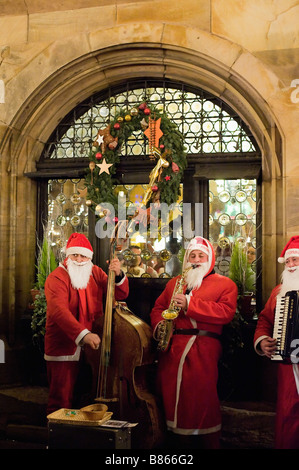 Straßenmusiker mit Weihnachtsmannskostümen buschend, Weihnachtszeit, Straßburg, Elsaß, Frankreich, Europa Stockfoto