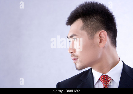 Nahaufnahme von junger Geschäftsmann drehen Kopf beiseite schließen sich Stockfoto