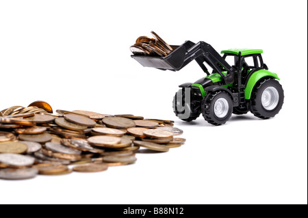 Grüner Traktor Rechen Münzen weißen Hintergrund Stockfoto