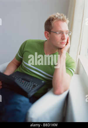 FV2638, Zoomphotographics; Mann Laptop sieht aus Fenster Stockfoto