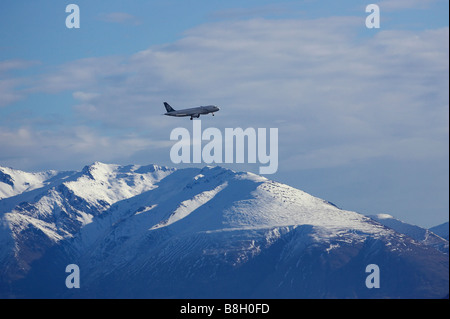 Air New Zealand Jet über Snowy Mountains in der Nähe von Queenstown Südinsel Neuseeland Stockfoto