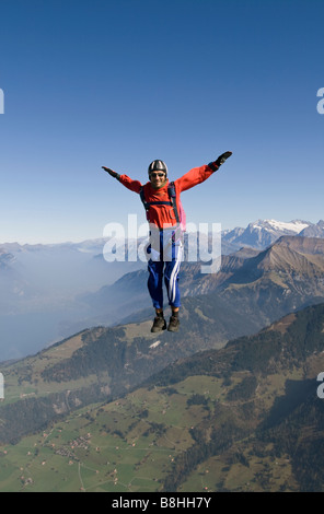 Fallschirmspringer ist Sit fliegen in den Himmel über die wunderschöne Berglandschaft. Der Spaß ist Taucher Freefly und Spaß in den blauen Himmel. Stockfoto