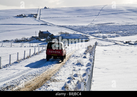 Dh Schottland Winter Straße STRASSEN UK Autofahren eisigen verschneiten Straßen schnee Orkney Auto ländlichen Bauernhof Landwirtschaft Stockfoto