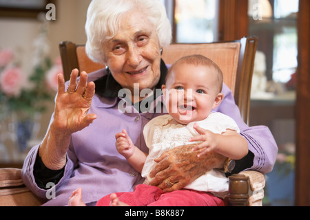 Großmutter ihre Enkelin auf Schoß halten Stockfoto