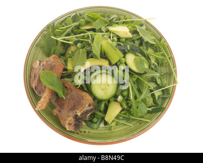 Ein frisch zubereitetes, zarte süße Lammkoteletts mit Avocado Salat und Rucola Blätter gegen einen weißen Hintergrund mit keine Menschen und einen Freistellungspfad isoliert Stockfoto