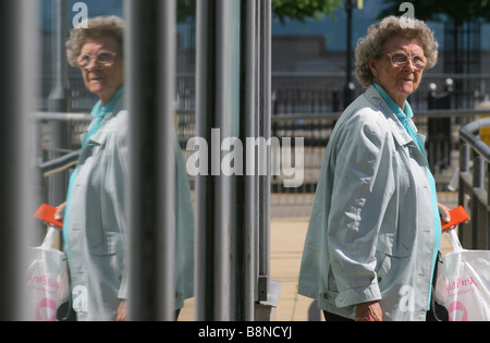 Eine ältere Frau wartet man an Bord eines Busses. Stockfoto