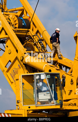 Krane heben von Lasten in Aktion bei Sabaudia in Italien Stockfoto