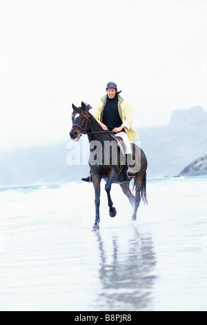 Reitpferd Mann am Strand Stockfoto