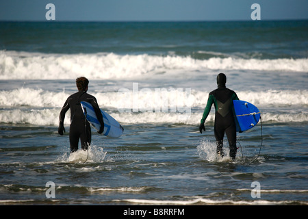 Zwei Surfer Dudes immer bereit, die Wellen am Widemouth Bucht in Cornwall, Südwestengland, UK. Stockfoto