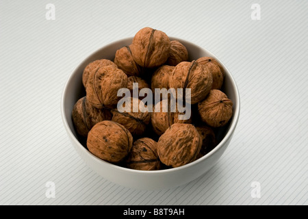 Muttern in eine Schüssel geben Stockfoto