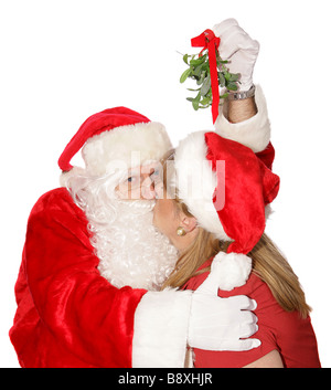 Santa ist einen Kuss unter dem Mistelzweig immer bei der Weihnachtsfeier am Nordpol Stockfoto