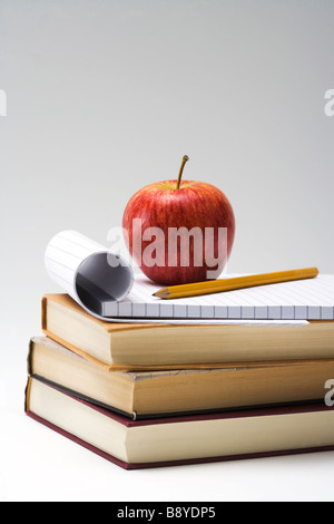 Ein roter Apfel und Bücher Nahaufnahme. Stockfoto
