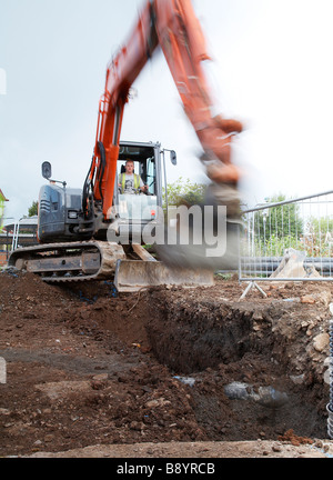 JCB einen Graben auf einer Baustelle. Stockfoto