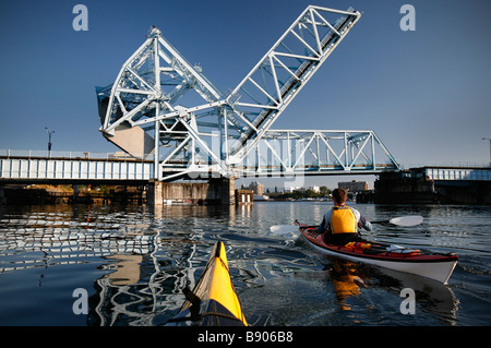 Meer Kajakfahrer paddeln unter der Johnson Street Bridge im Inner Harbour von Victoria auf Vancouver Island, British Columbia, Kanada. Stockfoto