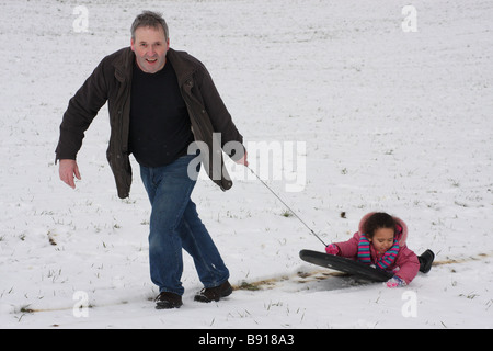 Tochter weißen Vater Tochter Toddlerl schwarzen ethnischen Mischlinge glücklich lächelnd Spaß Schnee Eis junge Stockfoto