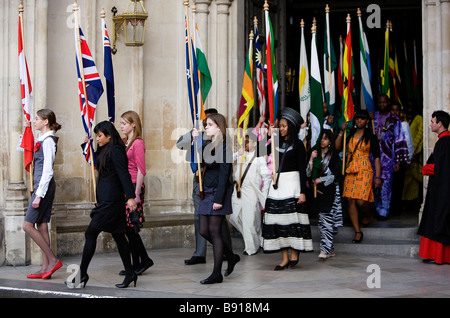 Junge Menschen mit den Fahnen des Commonwealth verlassen Westminster Abbey in London nach dem Commonwealth Tag Einhaltung Ser Stockfoto