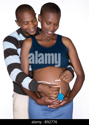 Erhöhte Ansicht der schwangeren Frau und Partner messen ihr Bäuchlein Studioaufnahme Stockfoto