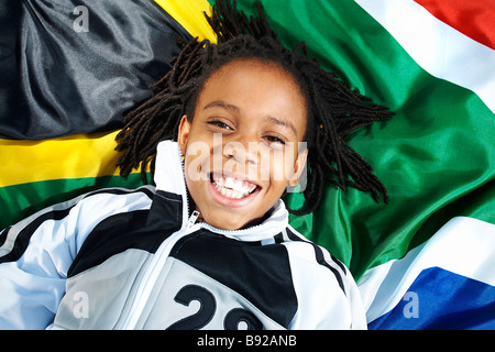 Junge liegend auf südafrikanische Flagge Zoolake Park Johannesburg Gauteng, Südafrika Stockfoto