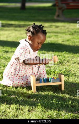 Tochter spielt auf dem Rasen mit ihrem Holzspielzeug Dewaal Park Cape Town Western Cape Provinz South Africa Stockfoto