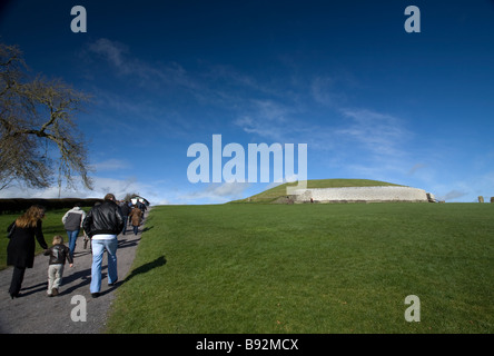 Touristen, die zu Fuß in Richtung Newgrange Durchgang Grab County Meath Ireland Stockfoto