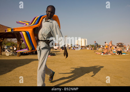 Männliche Strand mieten Arbeiter mit stapelbare Stühle am Strand, Porträt, Totes Meer, Israel, Naher Osten Stockfoto