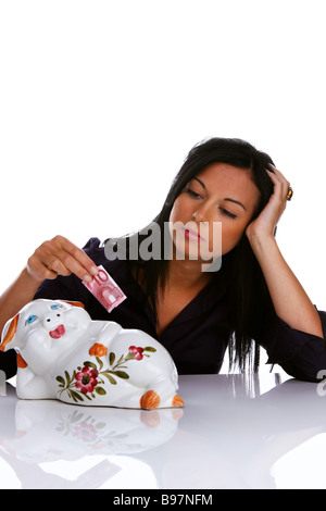 Junge Frau mit Sparschwein Stockfoto