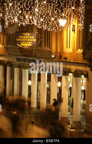 Von Chester, England. Nachtansicht einer anstrengenden shopping Weihnachten Szene Chesters Eastgate Street. Stockfoto