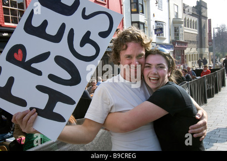 Ein junges Paar umarmen einander spontan in zentralen Brighton East Sussex UK nur für den Spaß an der Sache Stockfoto