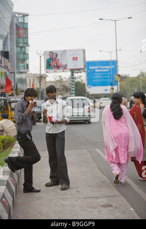 Indien Hyderabad Banjara Hills wohlhabenden Bezirk Männer betrachten Frauen beim Essen Fast-food Stockfoto