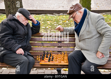 Zwei Männer spielen Schach auf einer Bank in einer Straße von Riga, Lettland, Europa Stockfoto
