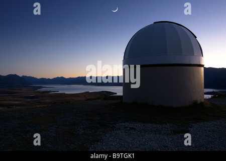 Mt John Observatorium und Mond Mondsichel in der Morgendämmerung am Lake Tekapo, Neuseeland. Stockfoto