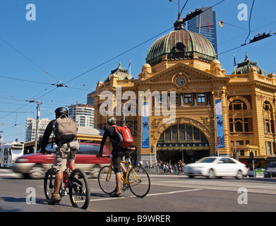 RADFAHRER WARTEN, UM CROSS ROAD VOR FLINDERS STREET RAILWAY STATION MELBOURNE VICTORIA AUSTRALIEN Stockfoto