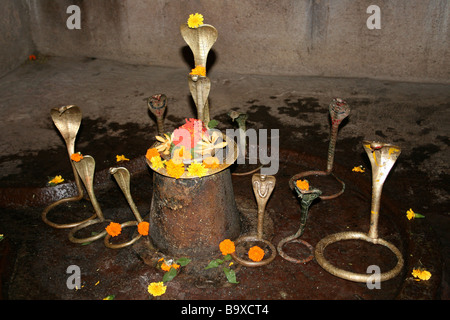 Tempel-Lingam Schrein mit Messing-Schlangen und Opfergaben an Hindu-Gott Shiva Stockfoto