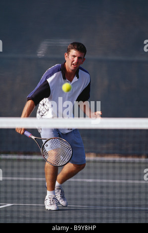 Junge männliche Tennisspieler in Aktion Stockfoto