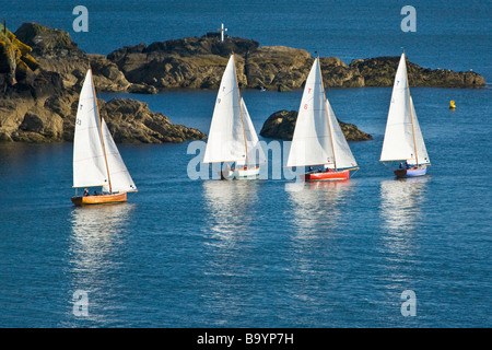 Troy Klasse Segelboote in Fluss Fowey Mündung Köpfen heraus zum Meer vorbei an Polruan. Stockfoto