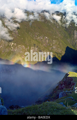 PERU MACHU PICCHU Shadow von Machu Picchu bei Sonnenaufgang und einem Herrlichkeit Halo reflektieren die Urubamba Berge und Wolken unter Stockfoto