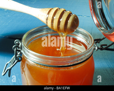 Honigglas Auf Löffel Honig Honig Honig im Glas auf der Theke Stockfoto