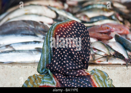 Muslimische Frau vor Fisch am Hafen de Peche in Nouakchott, Mauretanien Stockfoto