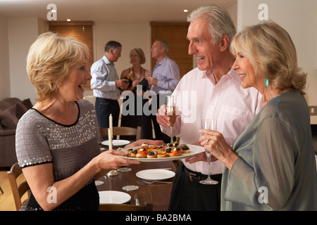 Frau Hors d ' oeuvres, ihre Gäste zu einem Dinner-Party Stockfoto