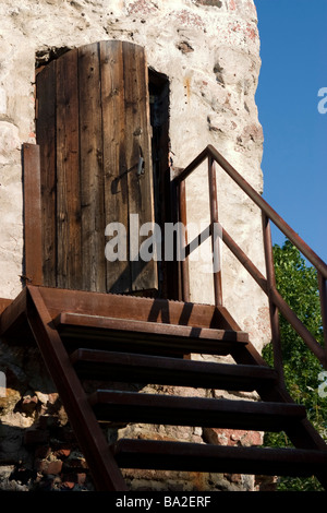 Metall Treppe zum alten Holztür. Stockfoto