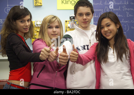 Physik-Unterricht Schüler Schultafel kommt Lächeln Blick Kamera Geste Daumen hoch Gruppenbild Klassenzimmer Stockfoto