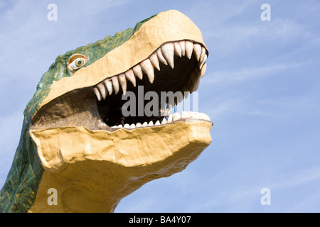 Statue des Dinosauriers mit offenem Mund gegen blauen Himmel Stockfoto