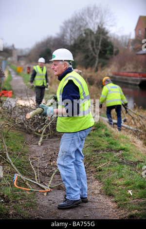 EINE WORK-PARTY AUS DEN COTSWOLD-KANÄLEN VERTRAUEN CLEARING BÄUME AUS DEM LEINPFAD IN STONEHOUSE ALS TEIL DER WIEDERHERSTELLUNG FUNKTIONIERT AUF T Stockfoto