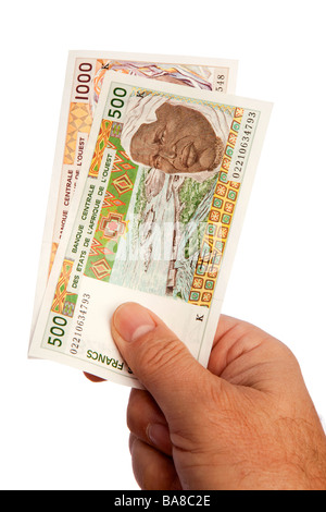 Geld männliche Hand, die Handvoll der senegalesischen CFA Währung Stockfoto