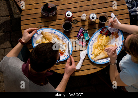 Menschen essen Fisch und Chips Stockfoto