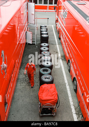 gestapelte Slick Rennreifen zwischen Ferrari Formel 1 LKW im Fahrerlager Stockfoto