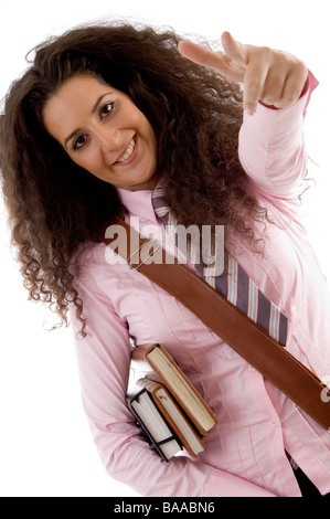 hübsche junge Studentin mit Büchern zeigen Stockfoto