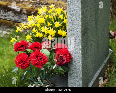 Blumen auf ein Grab auf einem Friedhof Stockfoto