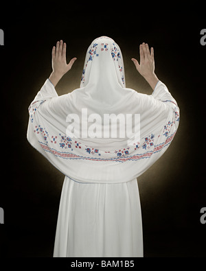 Rückansicht einer jungen muslimischen Frau beten