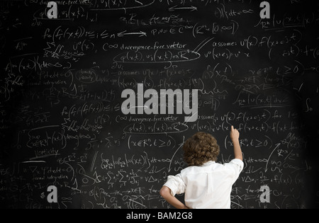 Junge mit Formeln auf Tafel Stockfoto